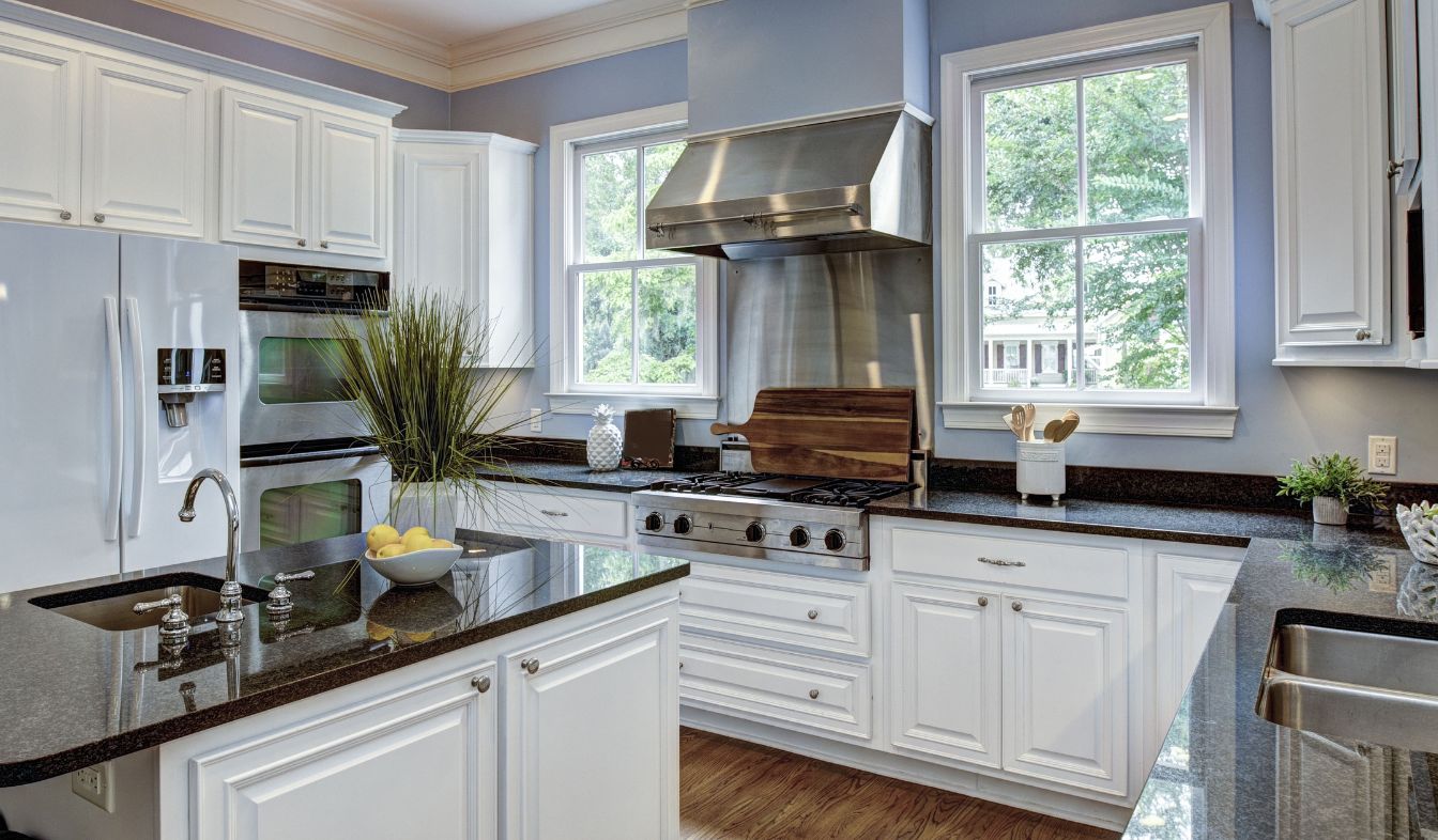 Remodeled open-plan kitchen with granite countertops and an island