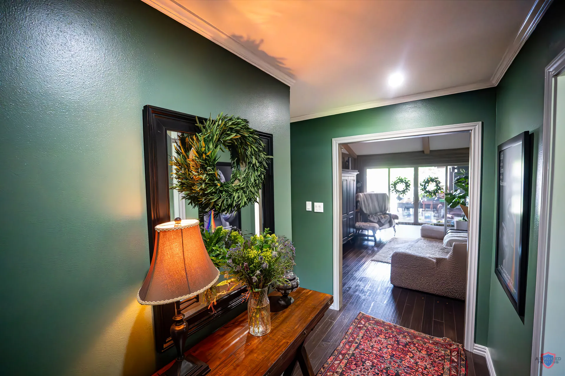 Entry hallway with a deep green accent wall and console table