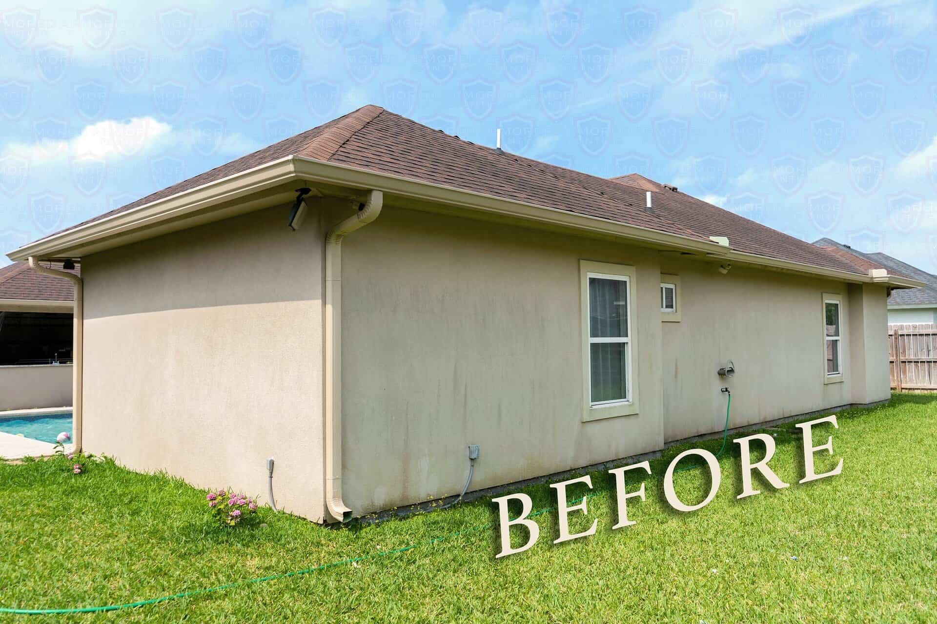 Stucco home exterior before painting, with weathered and stained walls