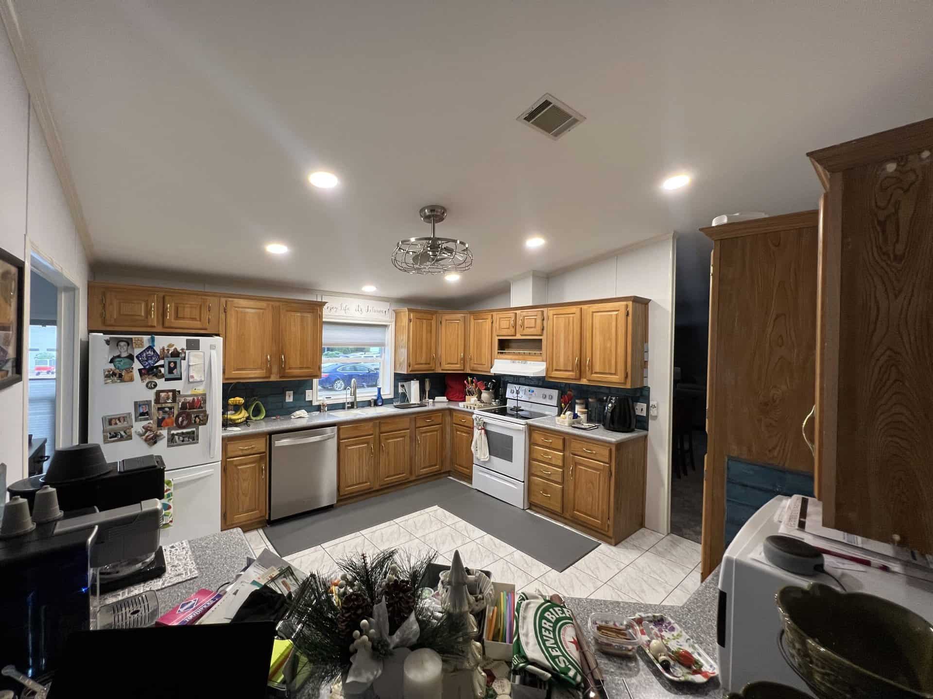Kitchen with dated oak cabinets before refinishing
