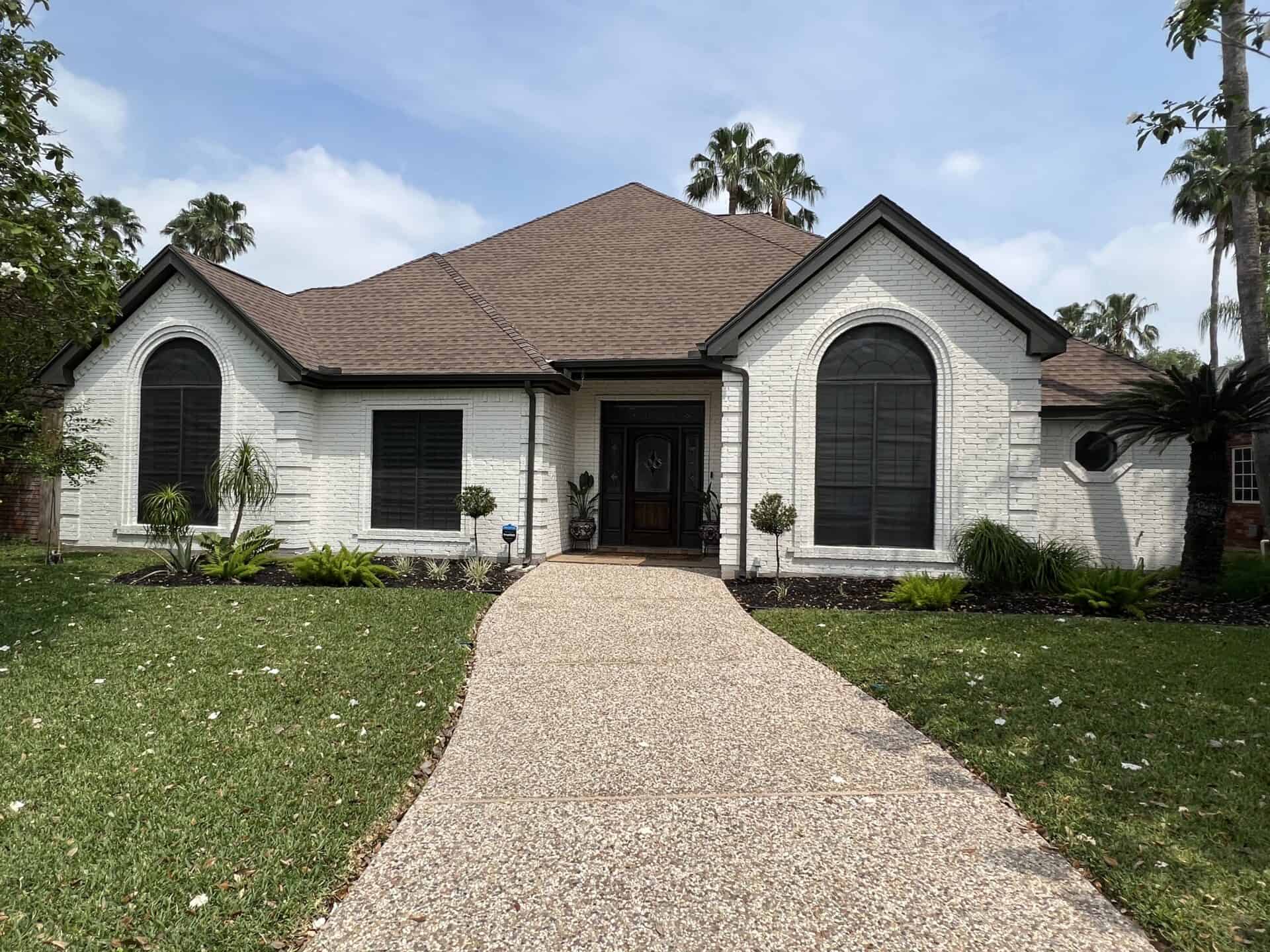 Freshly painted white brick home by Armored Painting
